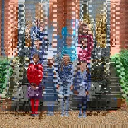 A selection of students who have won the Young Geographer of the Year competition standing on the steps of the Royal Geographical Society