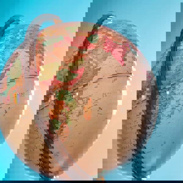 A white and red globe under a blue sky