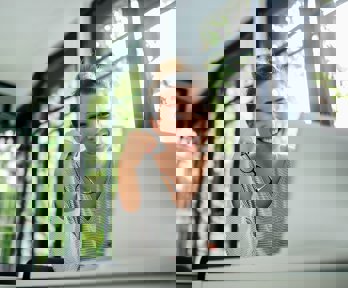 Female watching a lecture recording on their laptop.