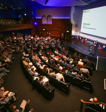 RGS Director Joe Smith welcomes attendees in the Ondaatje Theatre during the Explore 2024 opening address.
