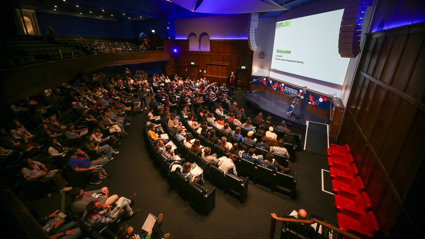 RGS Director Joe Smith welcomes attendees in the Ondaatje Theatre during the Explore 2024 opening address.