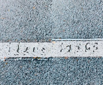 A tarmac floor with the word 'ideas' printed into it