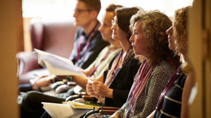Conference delegates listening attentively to a presentation.