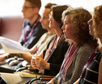 Conference delegates listening attentively to a presentation.