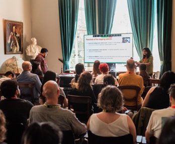 Presentation to audience in historic room at Royal Geographical Society.