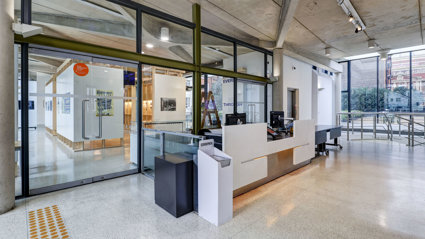The main hall with reception desk and exhibition pavilion space at the Royal Geographical Society.