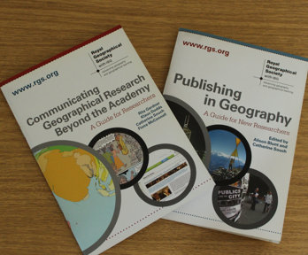 Two booklets on top of a wooden surface. The text on one booklet reads 'Communicating Geographical Research Beyond the Academy' and the other reads 'Publishing in Geography'.
