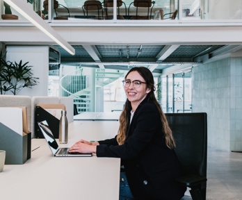 Person working on a laptop at a desk